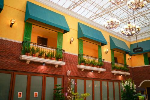a building with several balconies with plants on it at The Pepperland Hotel in Legazpi