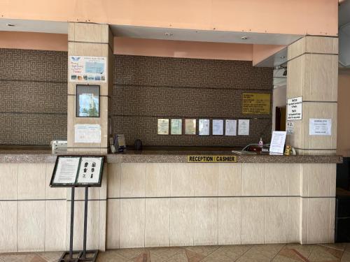 a ticket counter in a building with a phone at KUHARA COURT APARTMENT SUITE in Tawau