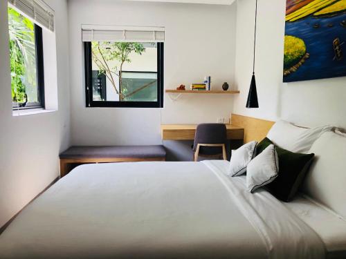 a bedroom with a large bed and a window at Green Peace Village in Da Nang