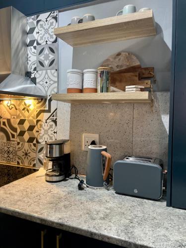 a kitchen with a counter with a toaster and a blender at Mdumela Stays 2 Bedroom Modern City Apartment in Pietermaritzburg