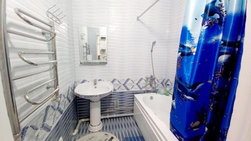 ein Badezimmer mit Waschbecken, Toilette und Badewanne in der Unterkunft 2х комнатная квартира в ЖК Отау сити in Schymkent