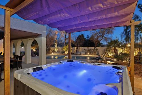 a jacuzzi tub on the patio of a house at Ranch style villa with pool and spa in Las Vegas