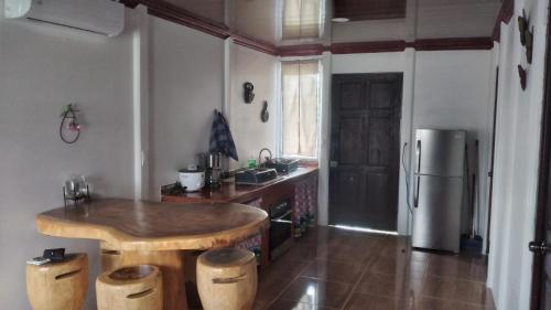 a kitchen with a wooden table and a refrigerator at Kri's house in Fortuna