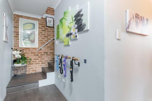 a hallway with a staircase with a brick wall at 1 Private Double Room in Berala near Station close to Olympic Park in Regents Park