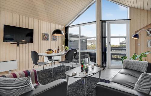 a living room with two tables and chairs and a tv at Beautiful Home In Otterup With Wifi in Otterup