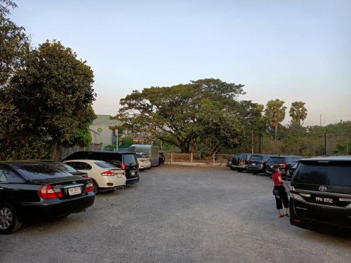 a bunch of cars parked in a parking lot at PS Hotel Saraburi in Sara Buri