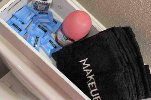 a drawer with a black towel and a pink ball at Spacious 3 BD Close To Everything! You’ll Love It! in Anchorage