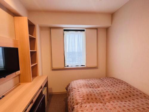 Ένα ή περισσότερα κρεβάτια σε δωμάτιο στο Park Inn Goshogawara Elmcity