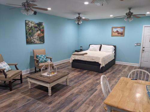 a bedroom with a bed and a table and chairs at Cozy studio with movie theater, beach 5 min away in Morehead City