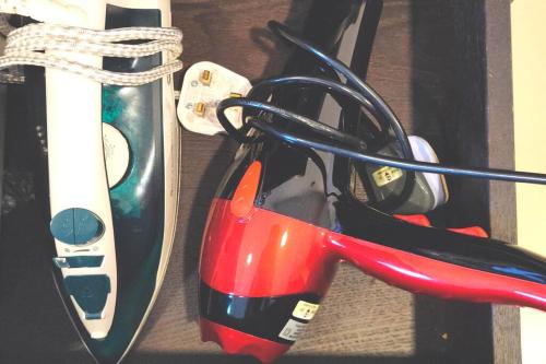 a pair of scissors sitting next to a wii controller at ANS Homestay Trefoil setia alam in Shah Alam