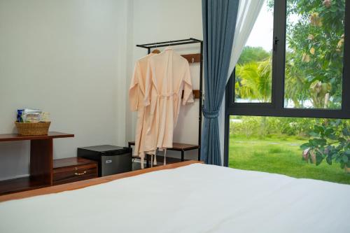 a bedroom with a bed and a window at Damnak Borey Resort in Kampot