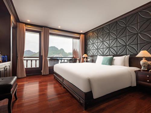 a bedroom with a large bed and a large window at Aqua Of The Seas Cruise Halong in Ha Long