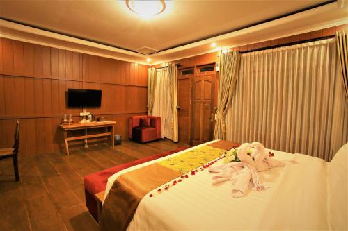 a hotel room with a bed with a stuffed animal on it at Kasuari Exotic Resort Magelang in Magelang