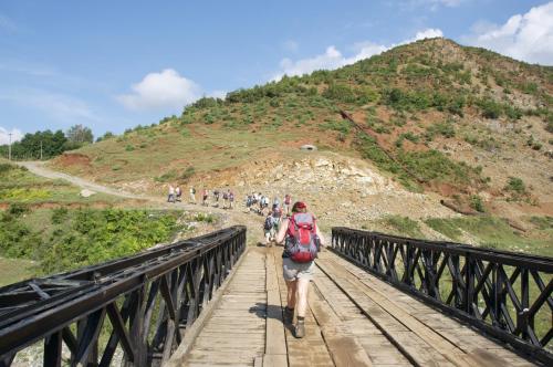 a group of people walking across a bridge at Aste Guesthouse in Tropojë