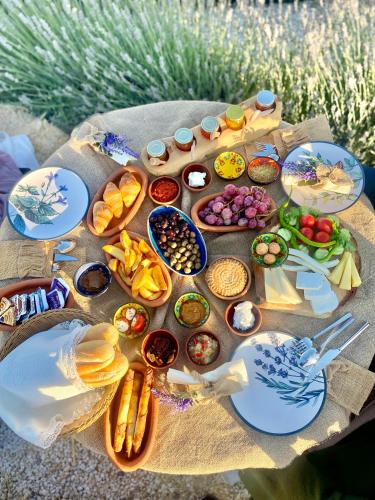 a table with food and plates of food on it at Wish Cappadocia in Uchisar