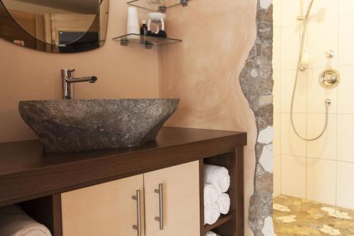 a bathroom with a sink and a shower at Haus Sonneneck - ski in & out in Sankt Anton am Arlberg