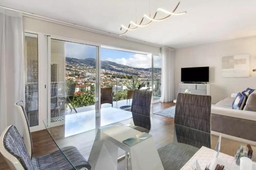 a living room with a view of a city at 1 Bed Apartment Sleeps 4 with Pool in Santo António