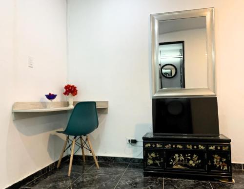 a bathroom with a sink and a mirror and a chair at Pacific Coast Hotel in Playa Bonita Village