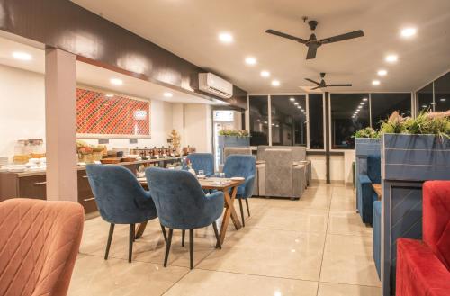 a dining room with blue chairs and a table at Amritara Kirpa, Amritsar in Amritsar