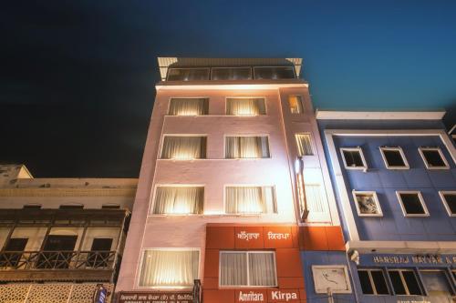 a tall building with lights on top of it at Amritara Kirpa, Amritsar in Amritsar
