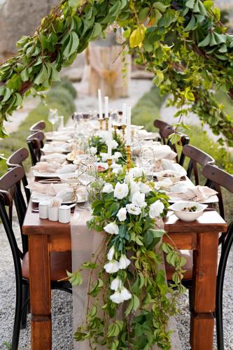 a long table with white plates and flowers on it at Wish Cappadocia in Uchisar