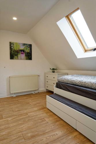 a attic bedroom with a bed and a skylight at Ferienhaus am Gurkenradweg in Stennewitz