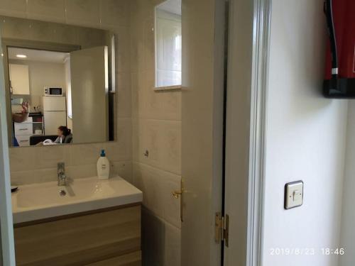 a bathroom with a sink and a mirror at Alquiler integro casa próxima a Colunga in Colunga