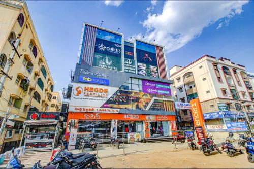 a city street with tall buildings and motorcycles at FabHotel SSR Fern Suites in Lingampalli