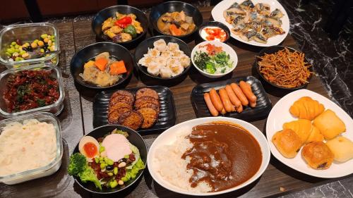 a table with many different dishes of food on it at APA Hotel TKP Tokyo Nishi-Kasai in Tokyo