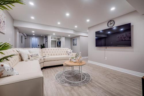 a living room with a white couch and a table at Vacation Suite in Pickering in Pickering