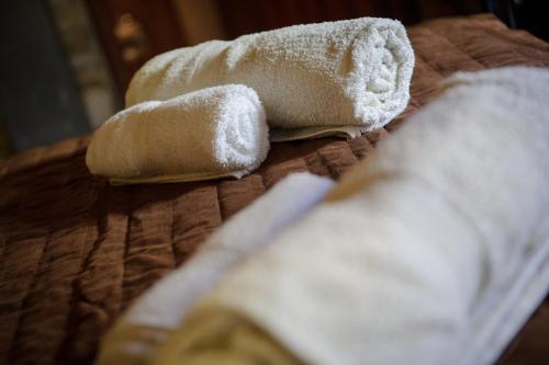 twee handdoeken zitten bovenop een bed bij Teacher's House in Maroni