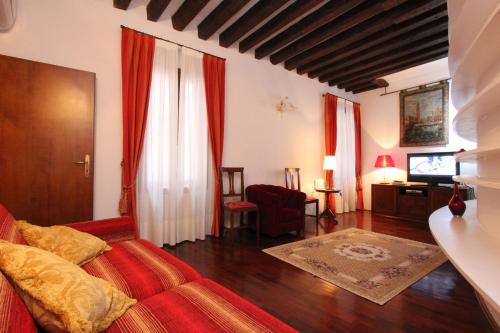 a bedroom with a bed and a living room at City Apartments San Marco in Venice