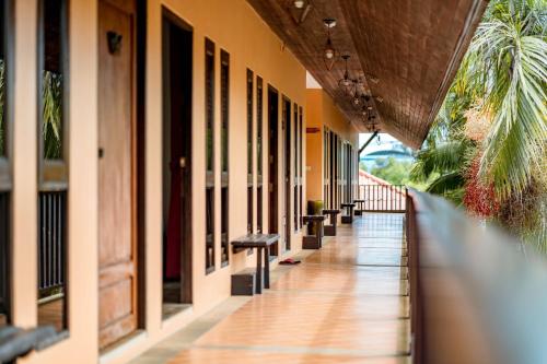 a hallway of a building with benches on the side at Kasalong Resort and Spa Pattaya in Pattaya Central