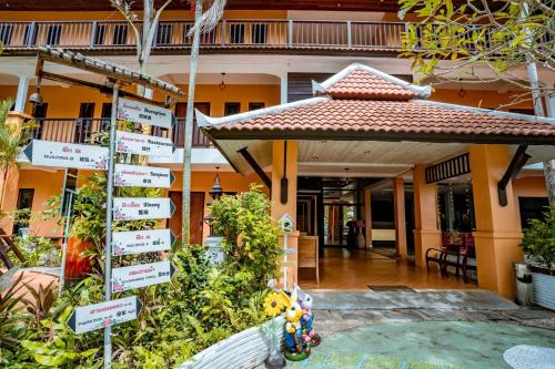 a sign in front of a building with plants at Kasalong Resort and Spa Pattaya in Pattaya Central