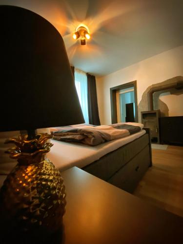 a bedroom with a bed and a table with a lamp at Flat Hundertwasser in Erfurt