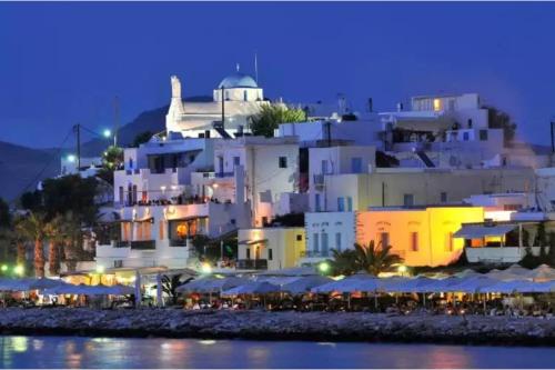 a view of a white building at night at Livadia Seaside Studios 6 in Parikia