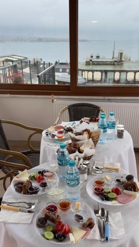 a table with plates of food and water bottles at Terrace Guesthouse in Istanbul
