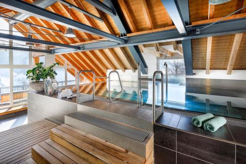 a bathroom with wooden ceilings and a sink with benches at Hotel Hirschen Wildhaus in Wildhaus