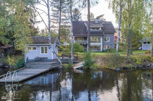 a house next to a body of water at Room by Lake 10 minutes from Tampere centrum in Lempäälä