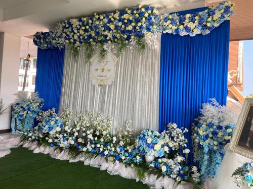a blue and white stage with blue and white flowers at Kasalong Resort and Spa Pattaya in Pattaya Central