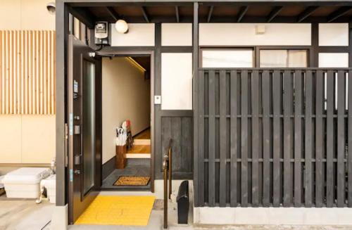 an entrance to a house with a gate at Kyoto-Toji house in Kyoto