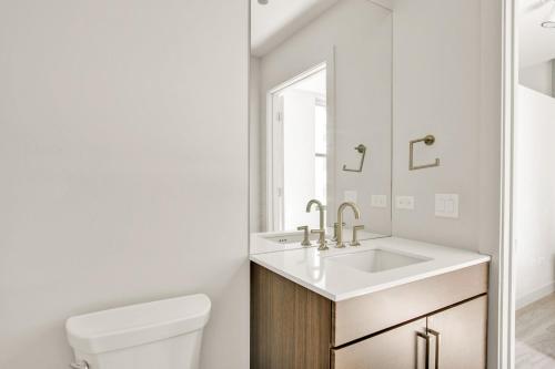 a white bathroom with a sink and a toilet at Loop 1BR w Gym Roofdeck nr Financial District CHI-201 in Chicago