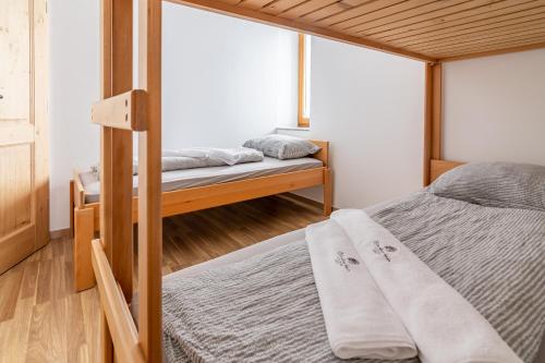 a bedroom with two beds and a window at Ribniška koča in Ribnica na Pohorju