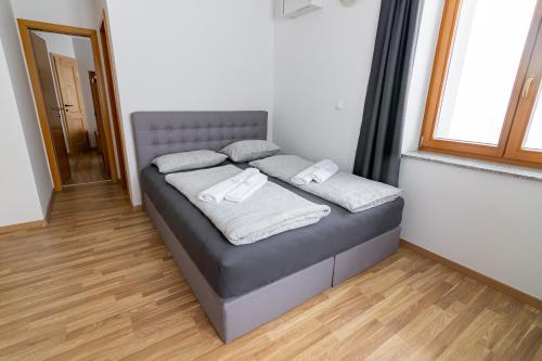a bed in a room with towels on it at Ribniška koča in Ribnica na Pohorju