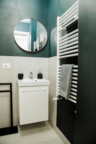 a bathroom with a white sink and a mirror at Terra Mia Suite in Catania