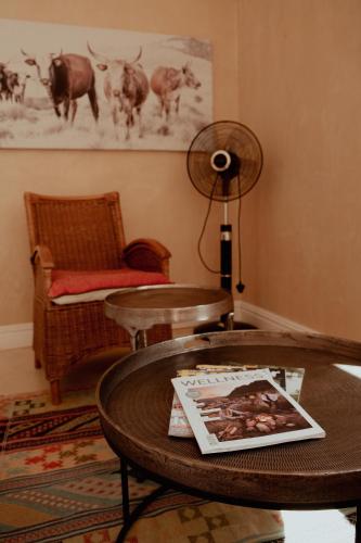 a living room with a table and a fan at The Bean Tree in McGregor
