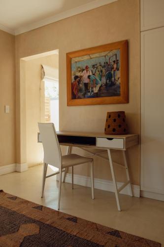 a desk with a chair and a painting on the wall at The Bean Tree in McGregor