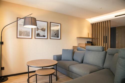 a living room with a couch and a table at AKASHA Beach Hotel & Spa in Hersonissos