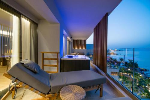 a room with a bed and a view of the ocean at AKASHA Beach Hotel & Spa in Hersonissos