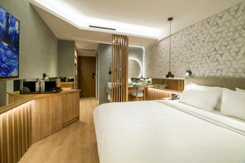 a hotel room with a bed and a kitchen at AKASHA Beach Hotel & Spa in Hersonissos